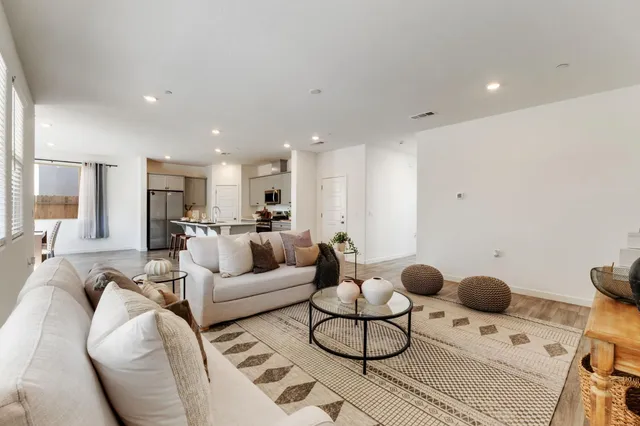 a living room with furniture and kitchen view