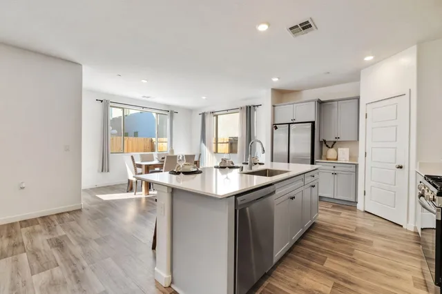 a kitchen with counter top space a sink appliances and cabinets