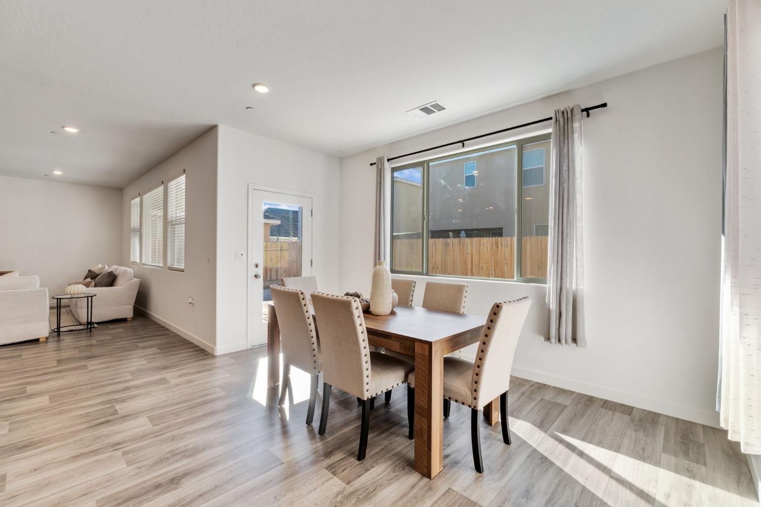2819 North Redda Road Fresno, CA 93737 - Photo 20 of 57 a view of a dining room with furniture and wooden floor