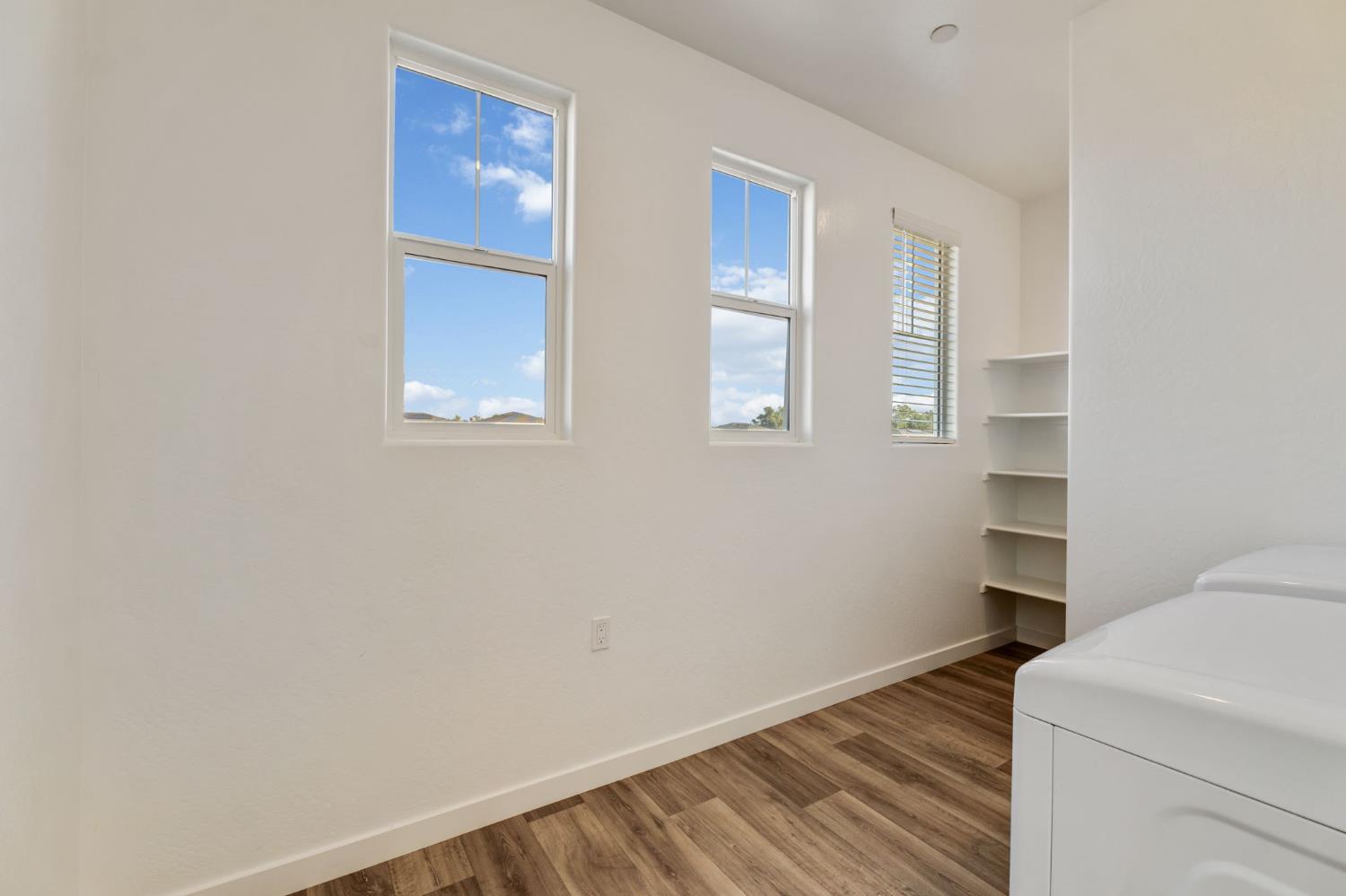 2819 North Redda Road Fresno, CA 93737 - Photo 23 of 57 a view of an empty room with wooden floor and a window