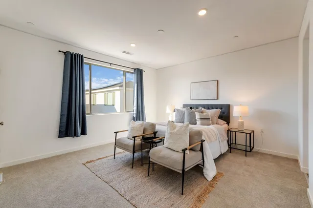 a bed room with a bed and a chair