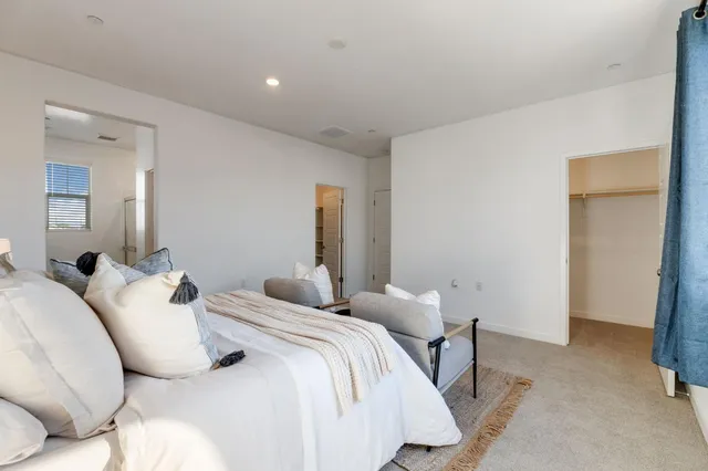 a bedroom with a bed and a lamp