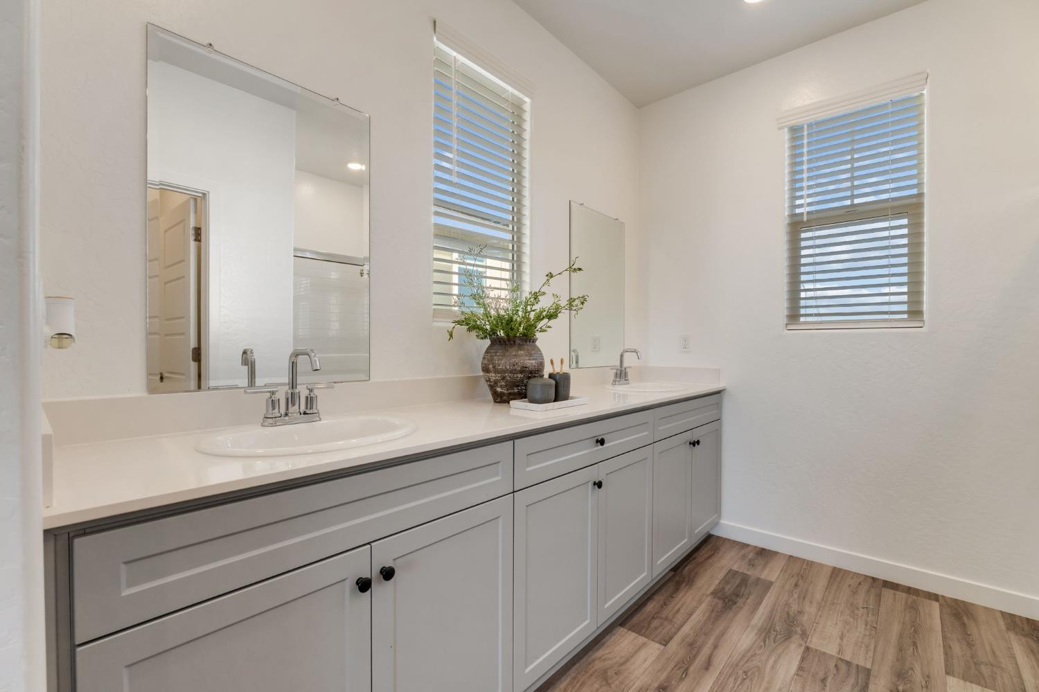 2819 North Redda Road Fresno, CA 93737 - Photo 30 of 57 a bathroom with a double vanity sink and a mirror