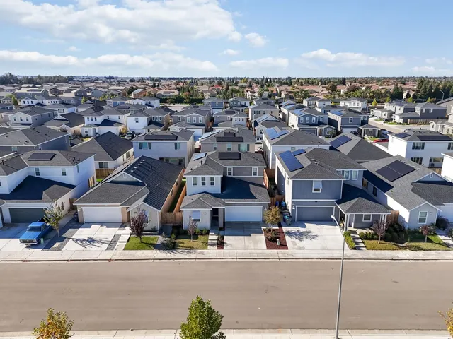 an aerial view of residential houses with outdoor space