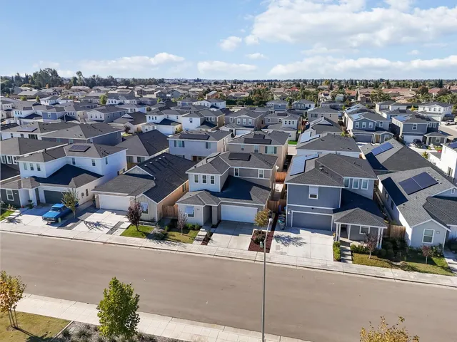 an aerial view of residential houses with outdoor space