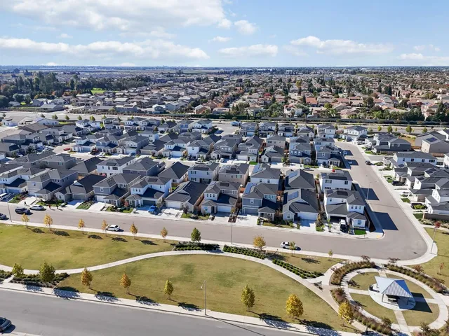 an aerial view of residential houses with outdoor space