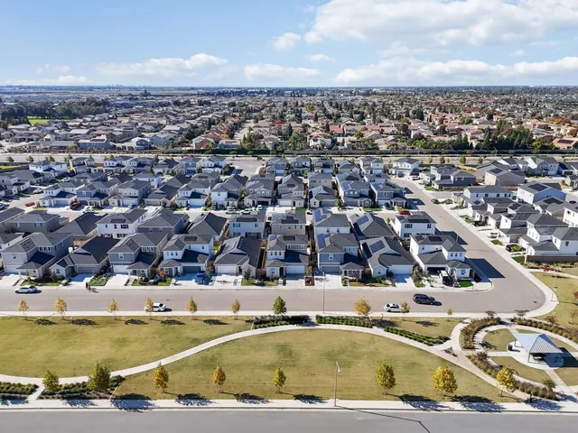 an aerial view of residential houses with outdoor space