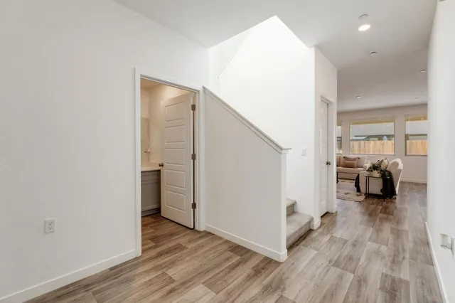 a view of a livingroom with a walk in closet with wooden floor