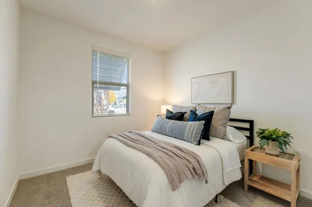 a bedroom with a bed and a window