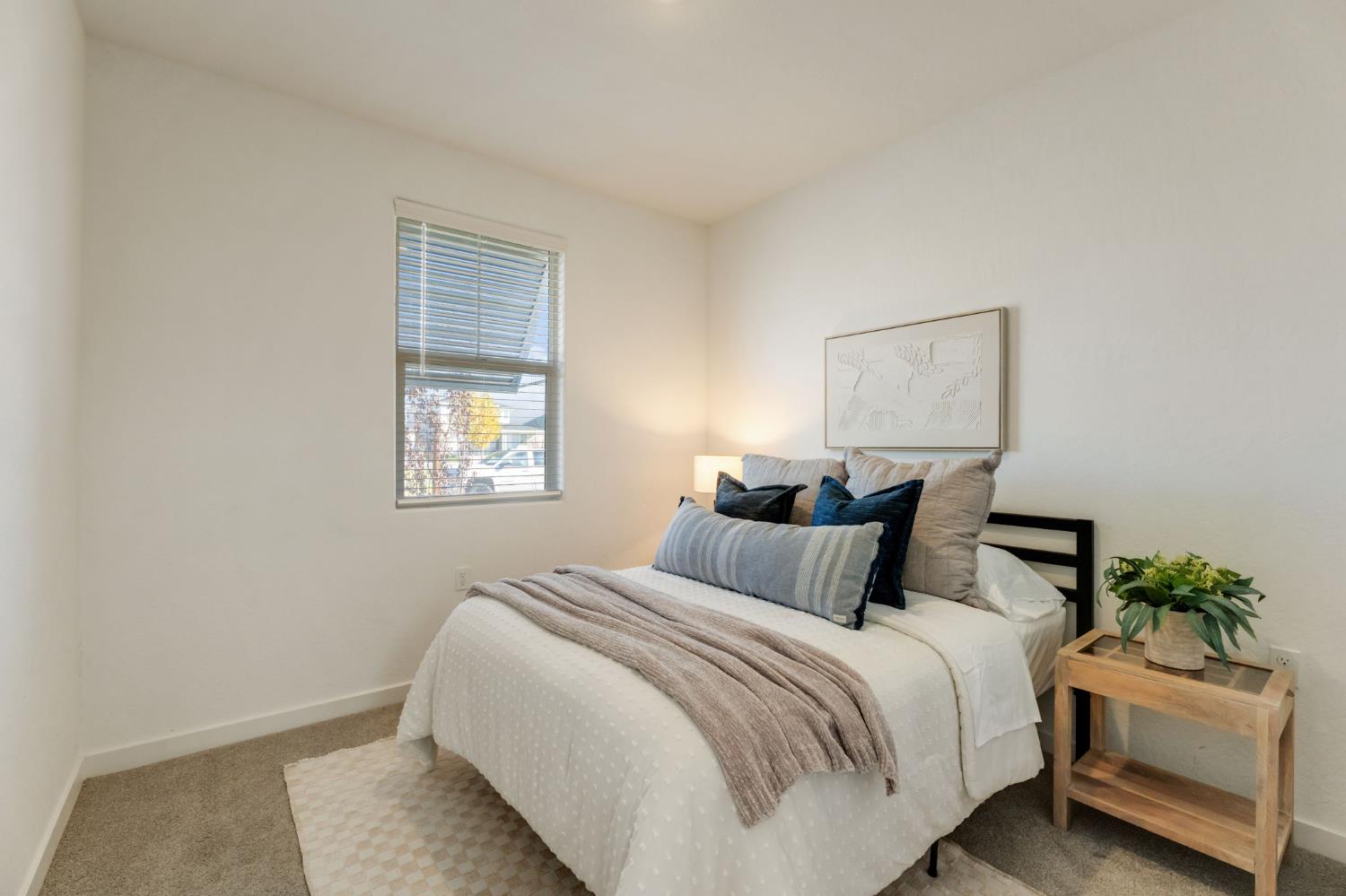 2819 North Redda Road Fresno, CA 93737 - Photo 8 of 57 a bedroom with a bed and a window