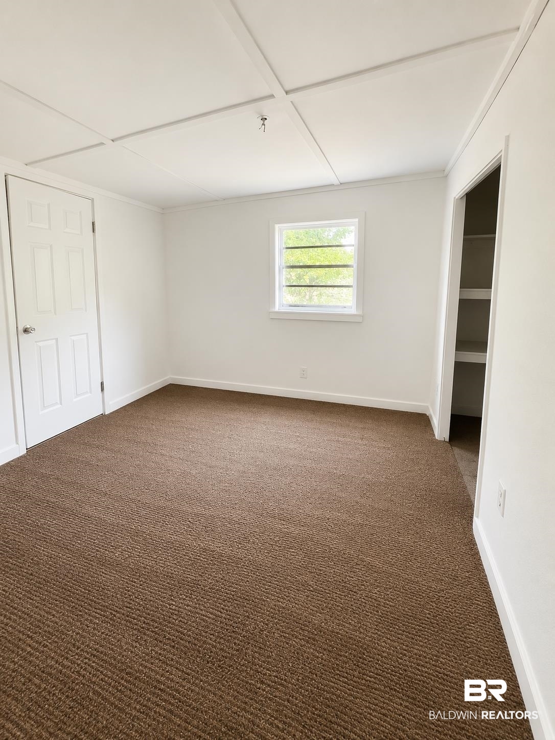 226 Elizabeth Street Evergreen, AL 36401 - Photo 33 of 35 Neutral wall finishes, textured brown carpeting, and a white paneled door