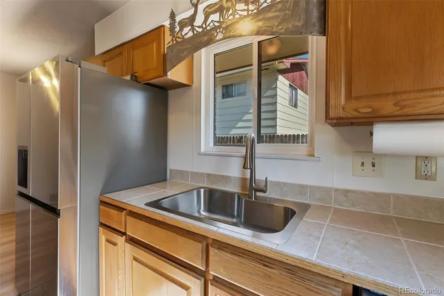a kitchen with a sink and refrigerator