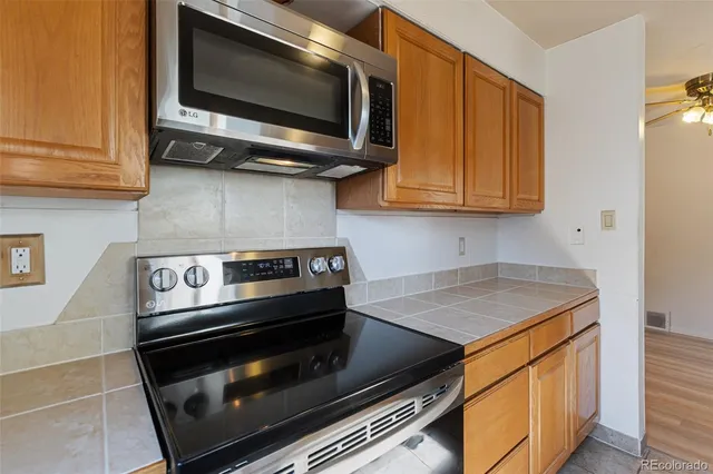 a kitchen with a stove and a microwave