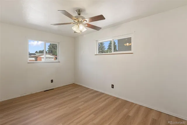 a view of empty room with wooden floor