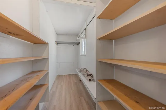 a view of walk in closet with empty racks