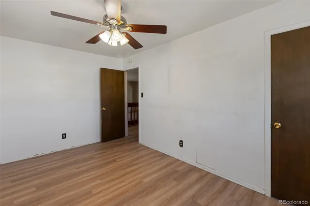 a view of a room with a ceiling fan