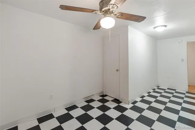 a bathroom with a black and white checkered floor