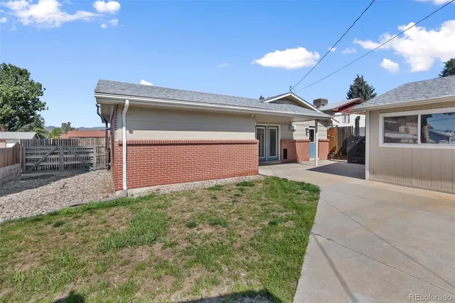a view of a house with wooden fence