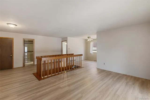 a view of hallway with wooden floor