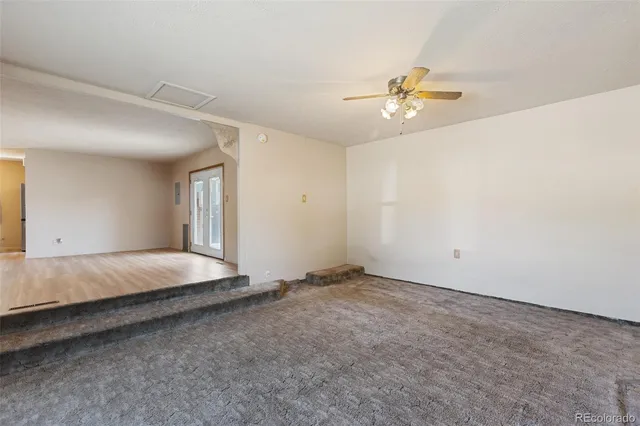 a view of a livingroom with a ceiling fan and window