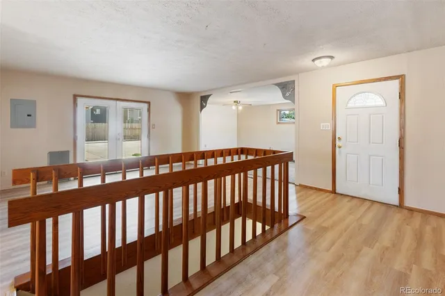 a view of hallway with wooden floor and stairs