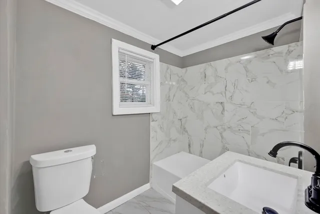 a bathroom with a toilet a sink and a shower