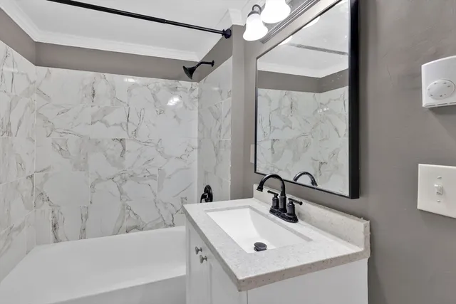 a bathroom with a sink a mirror and a bathtub