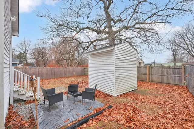 a white house covered with snow in front of house