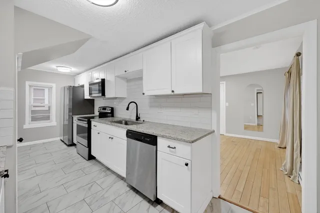 a kitchen with stainless steel appliances granite countertop a sink and cabinets