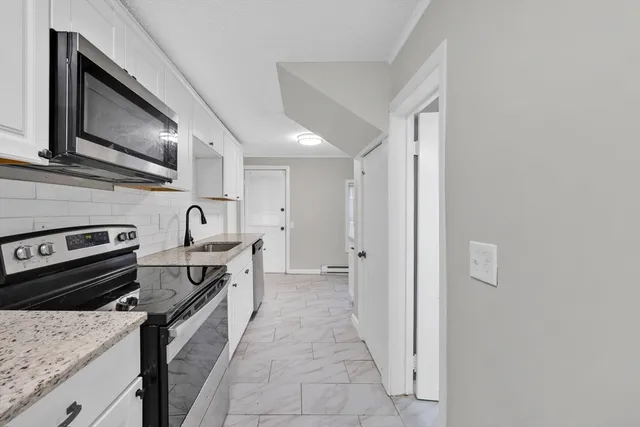 a kitchen with stainless steel appliances granite countertop a stove and a sink