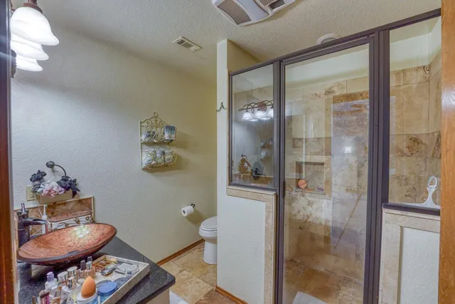 a bathroom with a toilet and a shower