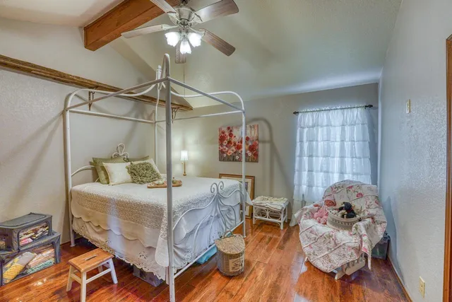 a bedroom with a bed and chandelier