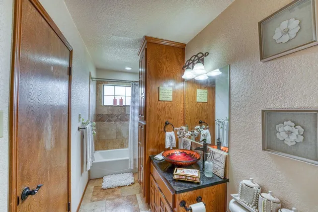 a bathroom with a mirror sink and toilet