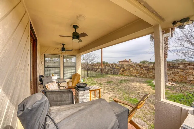 a living room with furniture and floor to ceiling windows