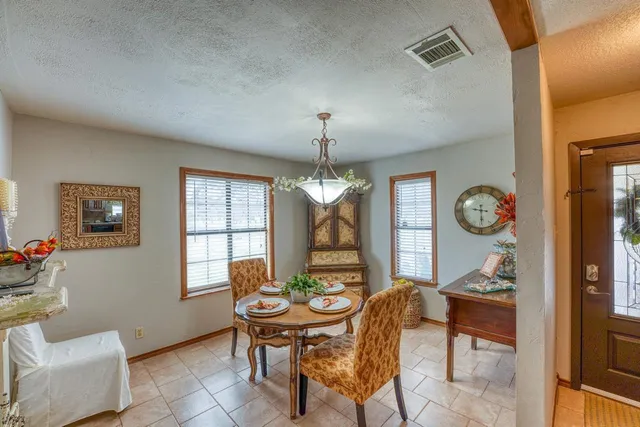a view of a dining room with furniture and a chandelier