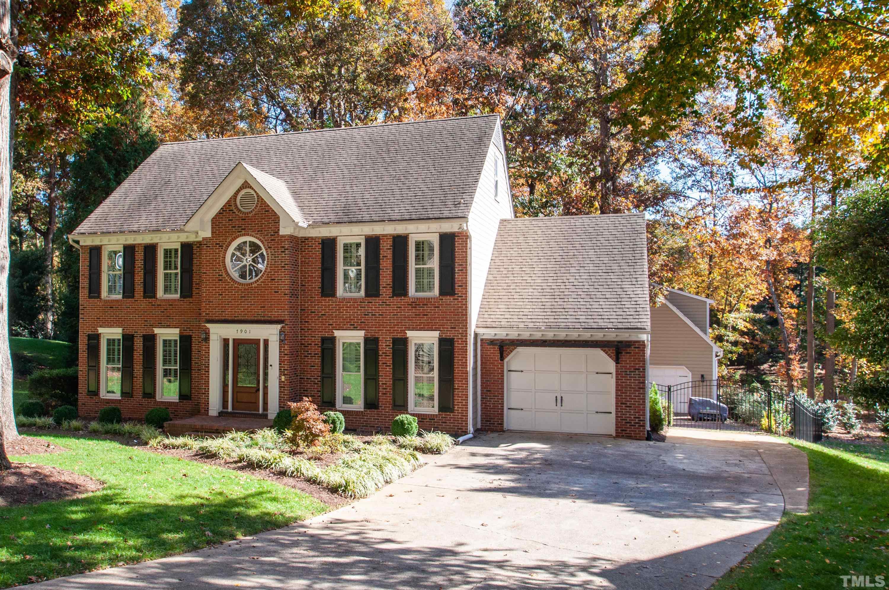 a front view of a house with garden and patio