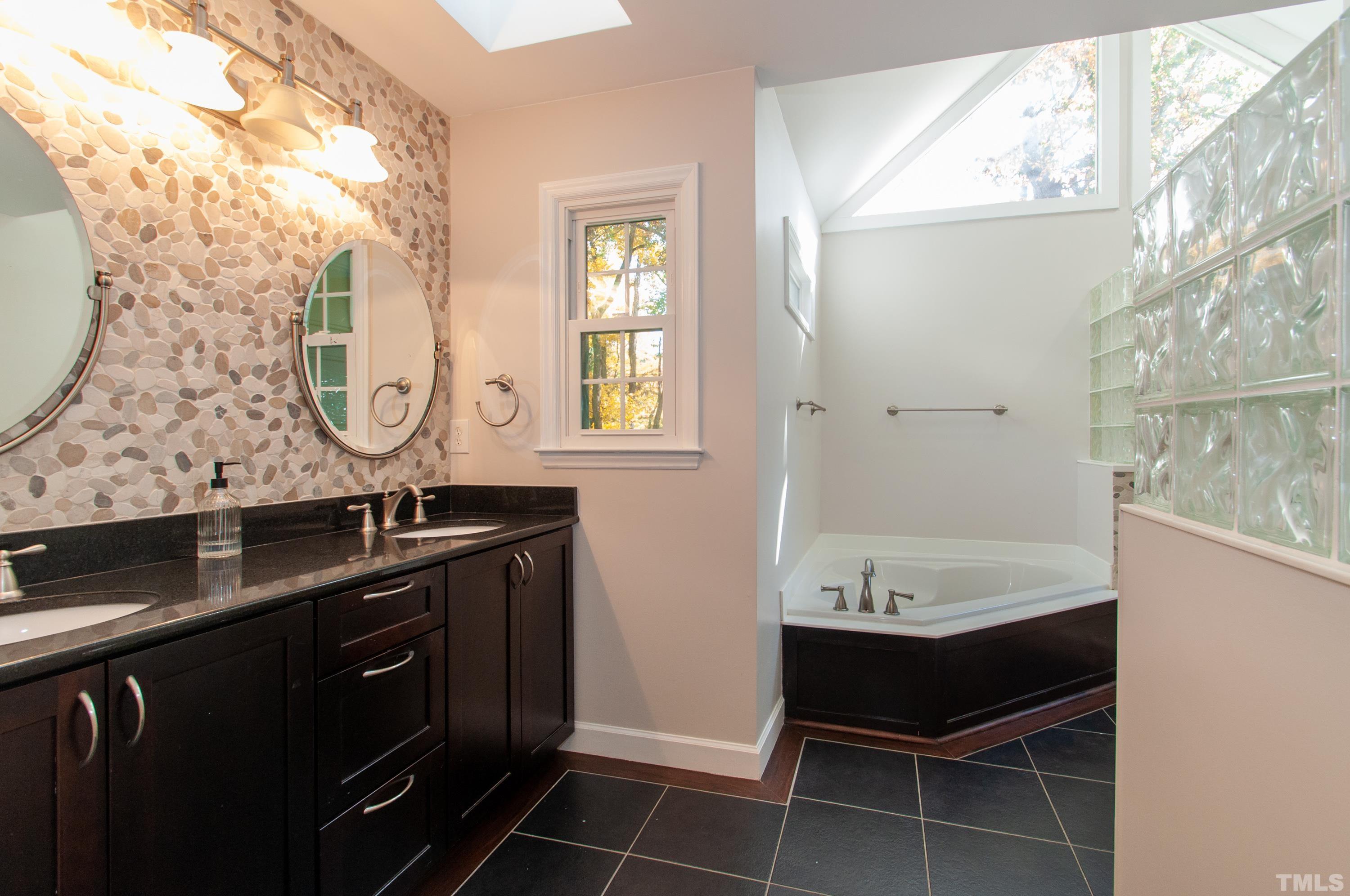 7901 Hepworth Court Raleigh, NC 27615 - Photo 16 of 30 a bathroom with a double vanity sink and a mirror