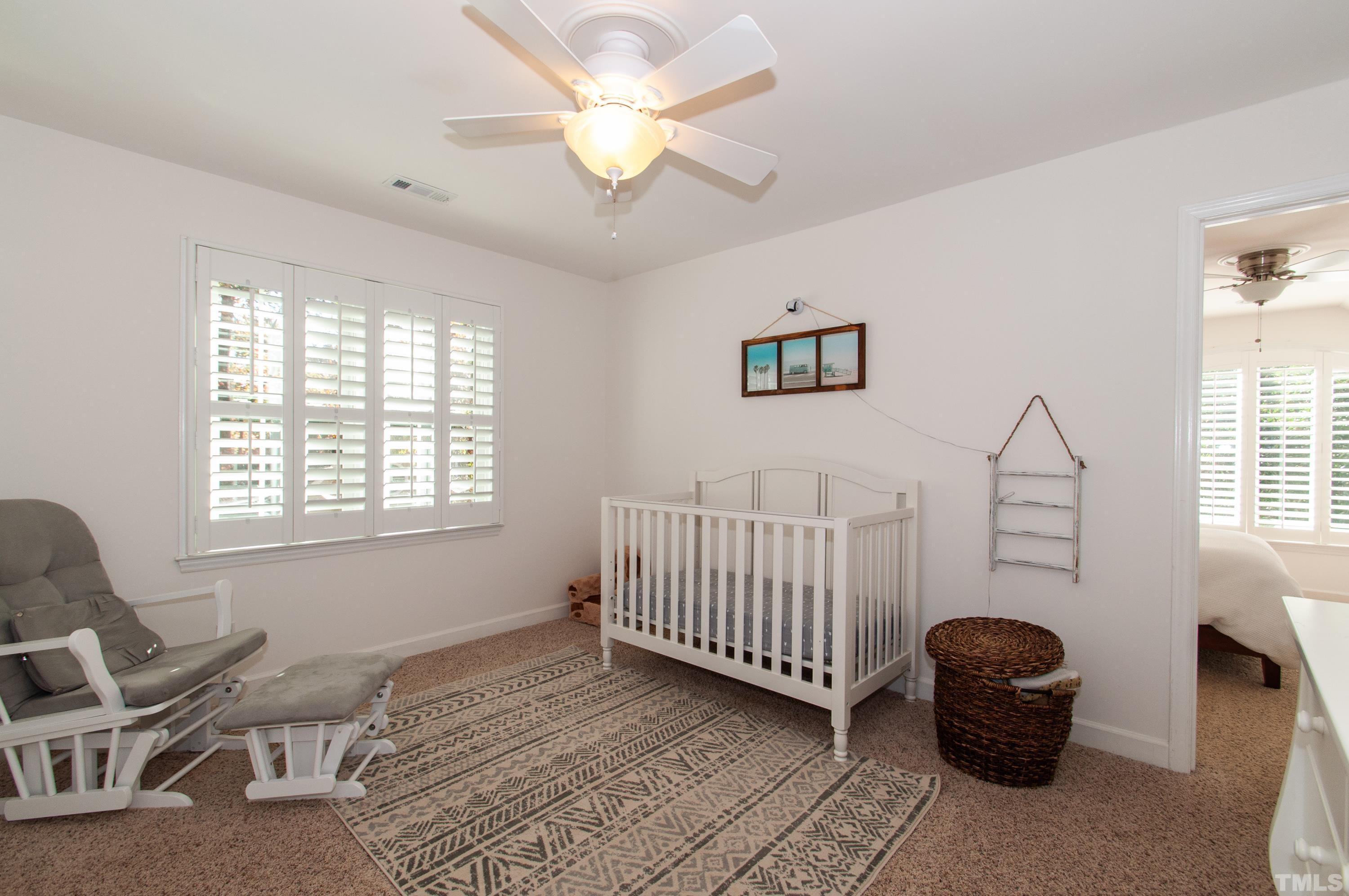 7901 Hepworth Court Raleigh, NC 27615 - Photo 18 of 30 a bedroom with a chair and window