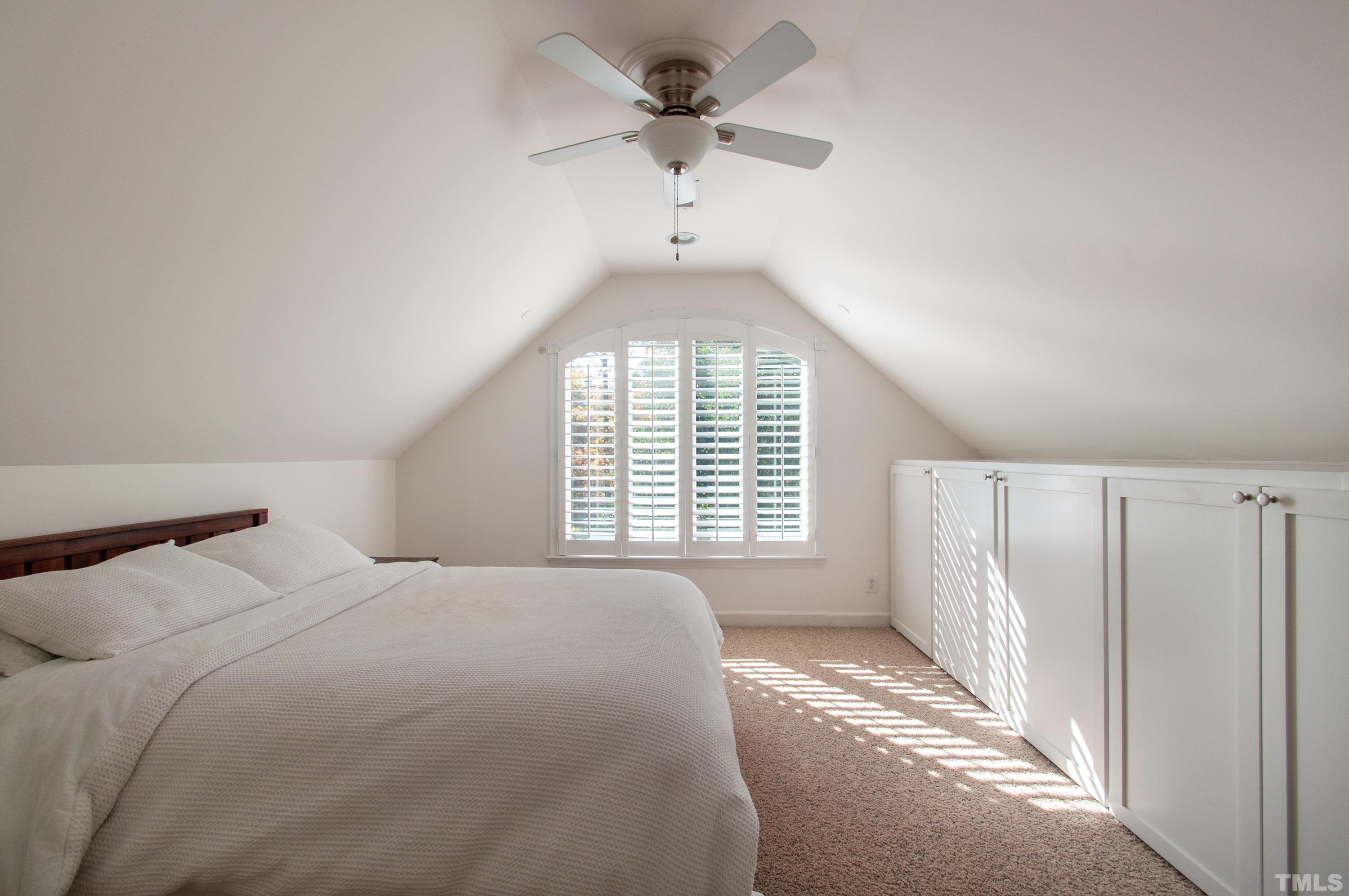 7901 Hepworth Court Raleigh, NC 27615 - Photo 19 of 30 a bedroom with a large bed and a chandelier