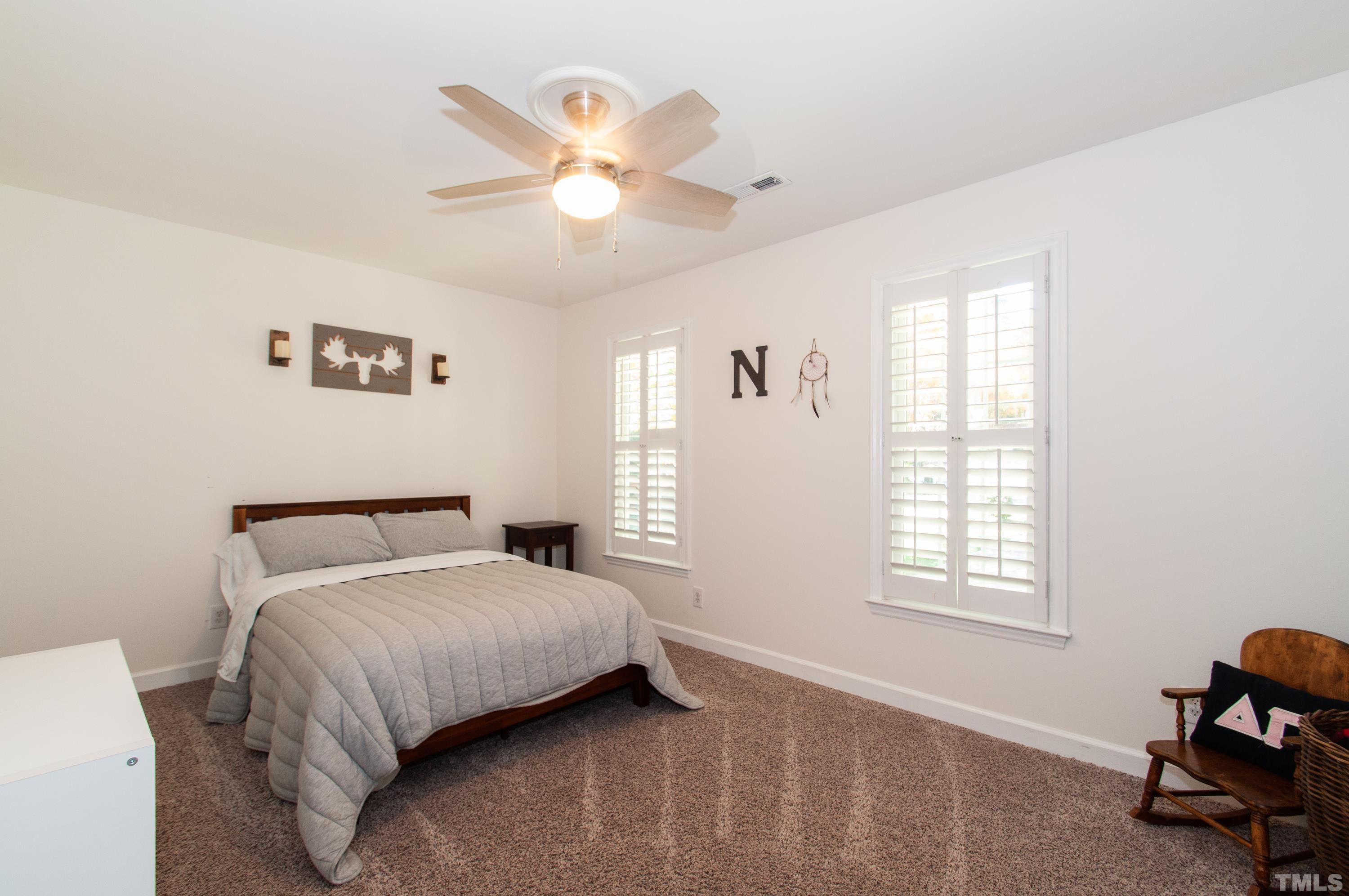 7901 Hepworth Court Raleigh, NC 27615 - Photo 21 of 30 a bedroom with a bed and a window