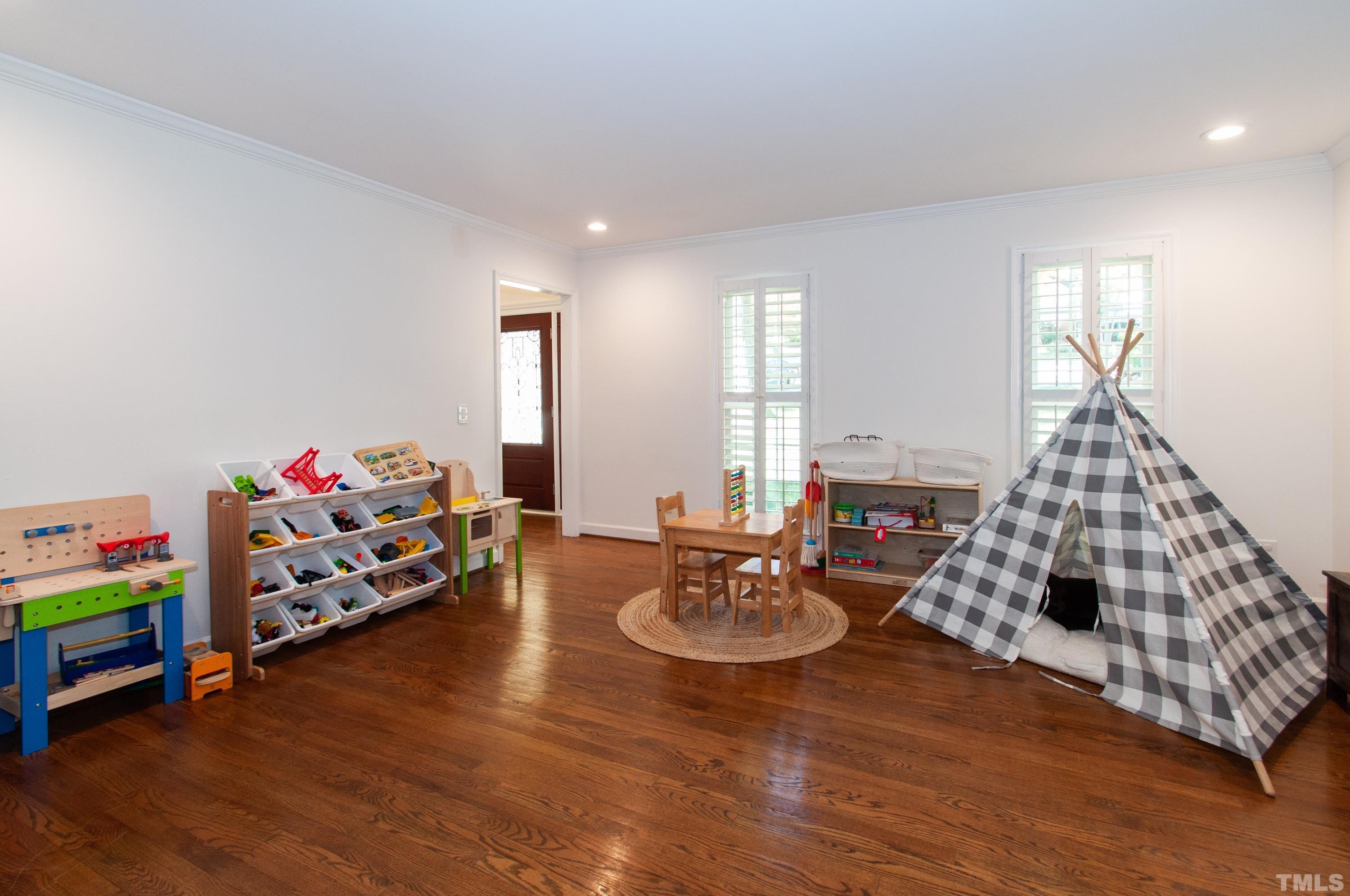 7901 Hepworth Court Raleigh, NC 27615 - Photo 4 of 30 a living room with furniture and a wooden floor