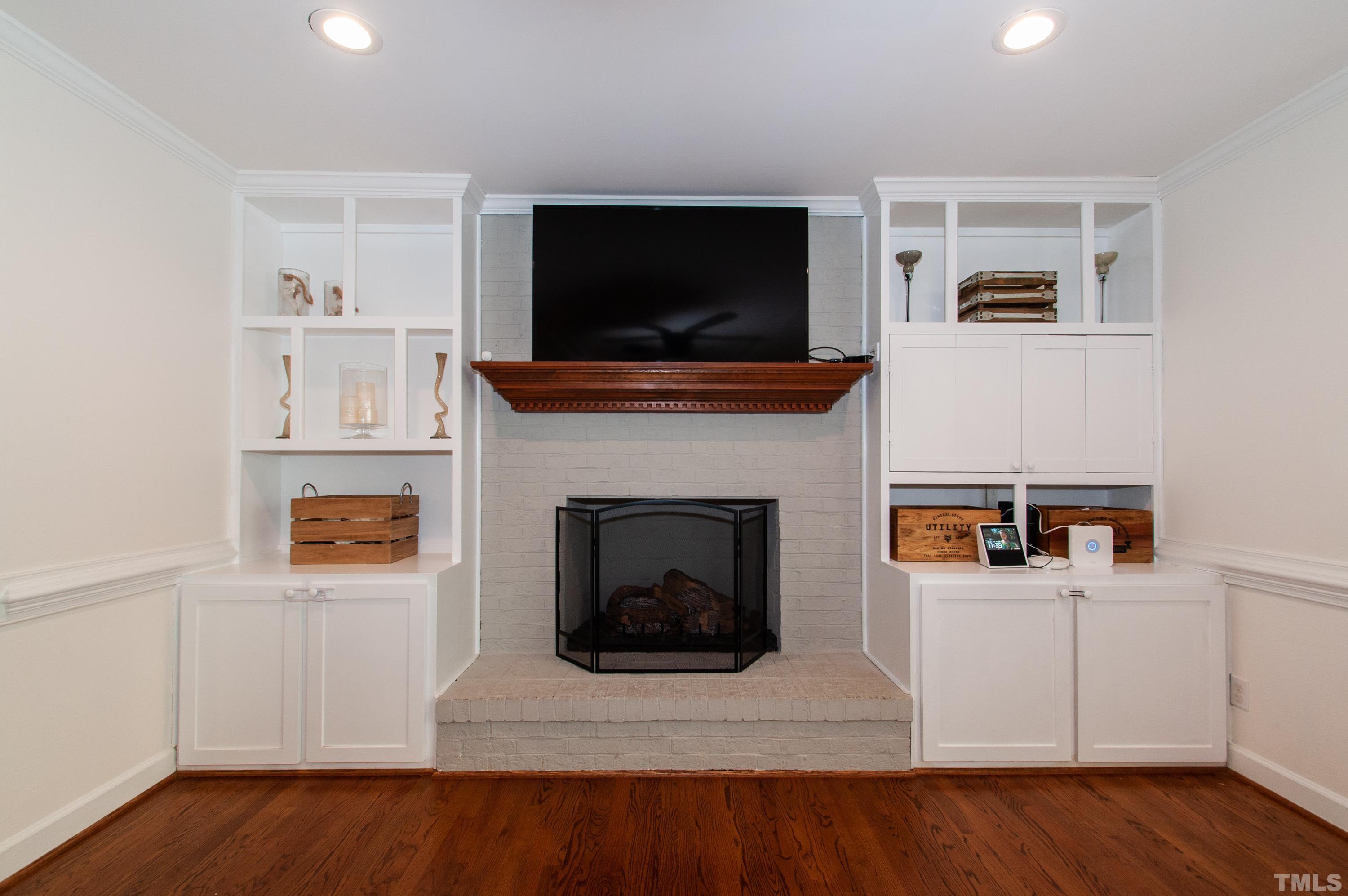 7901 Hepworth Court Raleigh, NC 27615 - Photo 6 of 30 a living room with furniture a flat screen tv and a fireplace