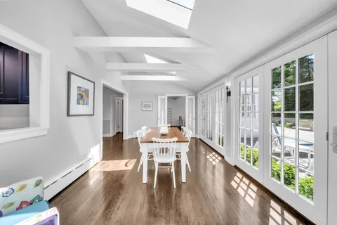 a view of a dining room with furniture window and wooden floor