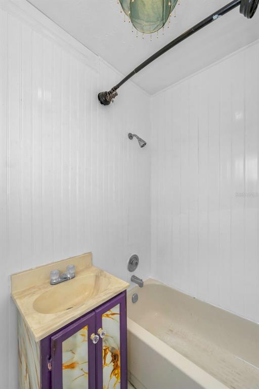 6126 Tennessee Avenue New Port Richey, FL 34653 - Photo 16 of 28 a bathroom with a tub sink and vanity