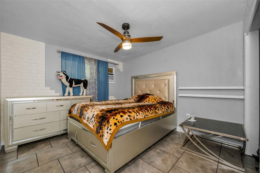 6126 Tennessee Avenue New Port Richey, FL 34653 - Photo 23 of 28 a bed room with a bed and a ceiling fan
