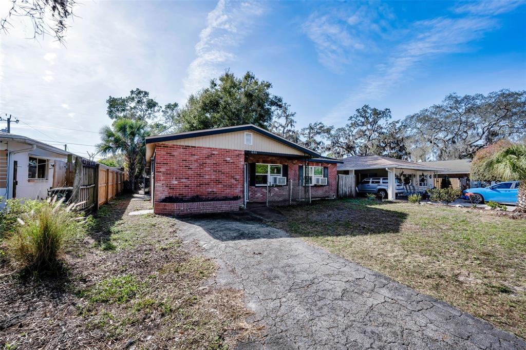 6126 Tennessee Avenue New Port Richey, FL 34653 - Photo 5 of 28 a front view of a house with garden