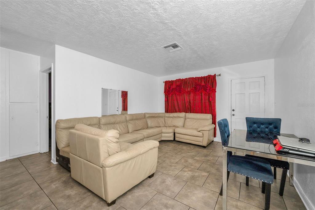 6126 Tennessee Avenue New Port Richey, FL 34653 - Photo 6 of 28 a living room with furniture and a couch