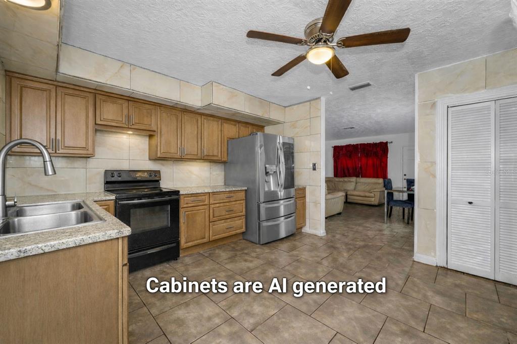 6126 Tennessee Avenue New Port Richey, FL 34653 - Photo 9 of 28 a kitchen with refrigerator and stove