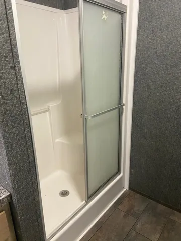 a bathroom with a glass shower door
