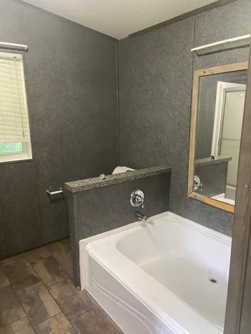 an empty room with wooden floor and a window